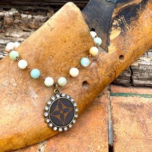 Beaded necklace with authentic LV emblem.